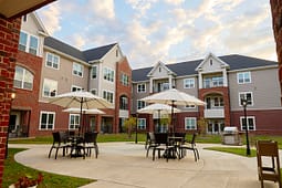 Apartment courtyard with patio tables and umbrellas