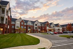 Brick apartment complex at sunset with driveway