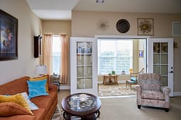Cozy living room with French doors and sunroom