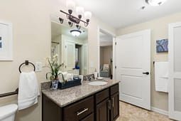Modern bathroom vanity with granite countertop and mirror