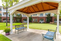 Covered gazebo with benches overlooking apartment courtyard