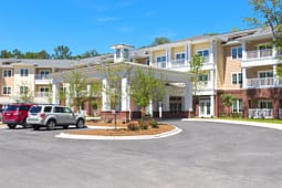 Modern apartment building with covered entrance and parking