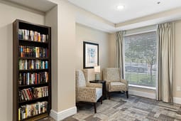 Cozy reading nook with bookshelf and armchairs