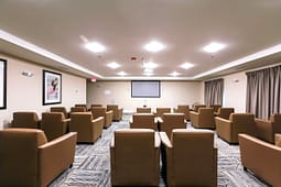 Small theater room with leather chairs and projector screen