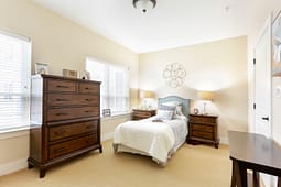 Cozy bedroom with single bed and wooden furniture