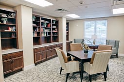 Modern office meeting room with bookshelves and table