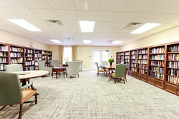 Bright library reading room with bookshelves and tables