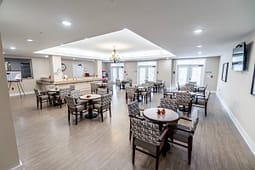 Spacious community dining room with tables and chairs
