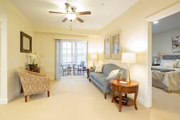Bright living room with balcony and bedroom view