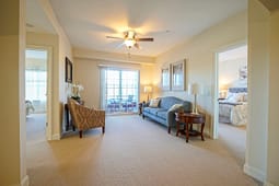 Bright living room with balcony and adjacent bedroom