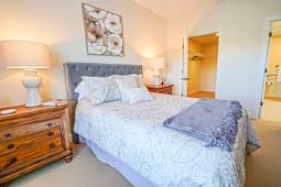 Cozy bedroom with tufted headboard and wooden nightstands