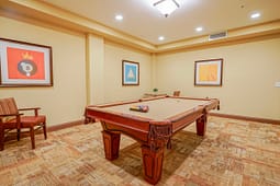 Billiards room with pool table and framed artwork
