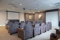 Small conference room with leather chairs and projector