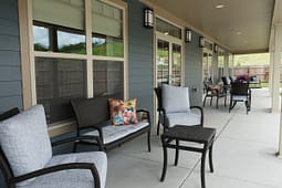 Covered patio with wicker seating and cushions