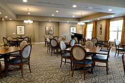 Elegant dining room with piano and round tables