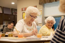 Seniors painting at a community art class