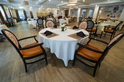 Elegant dining room with round tables and patterned chairs