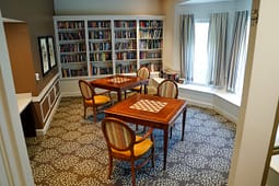 Cozy library room with chess tables and bookshelves