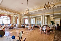 Elegant banquet hall with chandeliers and round tables