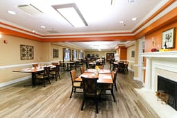 Spacious dining room with fireplace and wooden tables