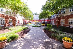 Landscaped courtyard with fountain and red umbrellas