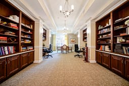 Elegant library room with desks and wooden bookshelves