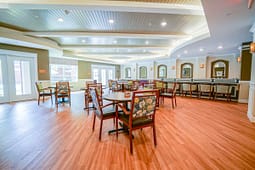 Spacious community dining room with round tables