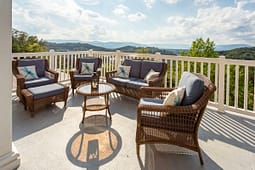 Wicker patio furniture overlooking scenic mountain landscape