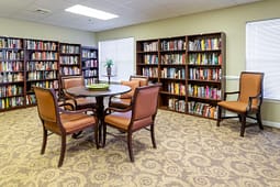 Cozy library reading room with bookshelves and table