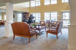Elegant lounge with leather chairs and grand piano
