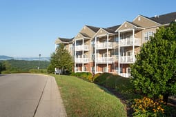 Apartment building with balconies beside landscaped road