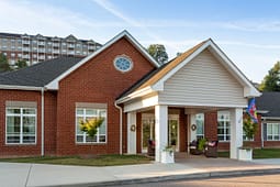 Brick apartment building entrance with covered portico