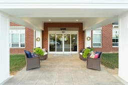 Brick building entrance with covered seating area