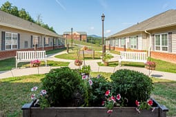 Landscaped courtyard between residential buildings with benches