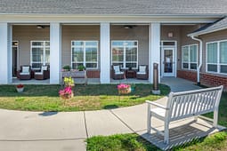 Covered patio with chairs and garden courtyard