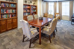 Cozy meeting room with table and bookshelves