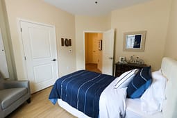 Modern bedroom with blue bedding and open door