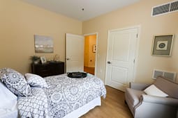 Cozy bedroom with patterned bedding and armchair