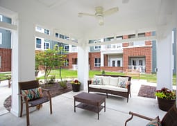 Covered patio with wicker seating in courtyard