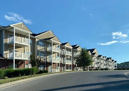 Modern apartment buildings with balconies along quiet street