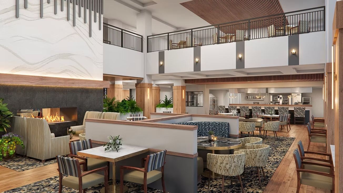Modern hotel lobby lounge with fireplace and mezzanine