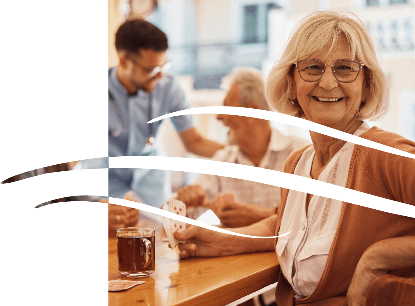 Smiling senior woman playing cards at table