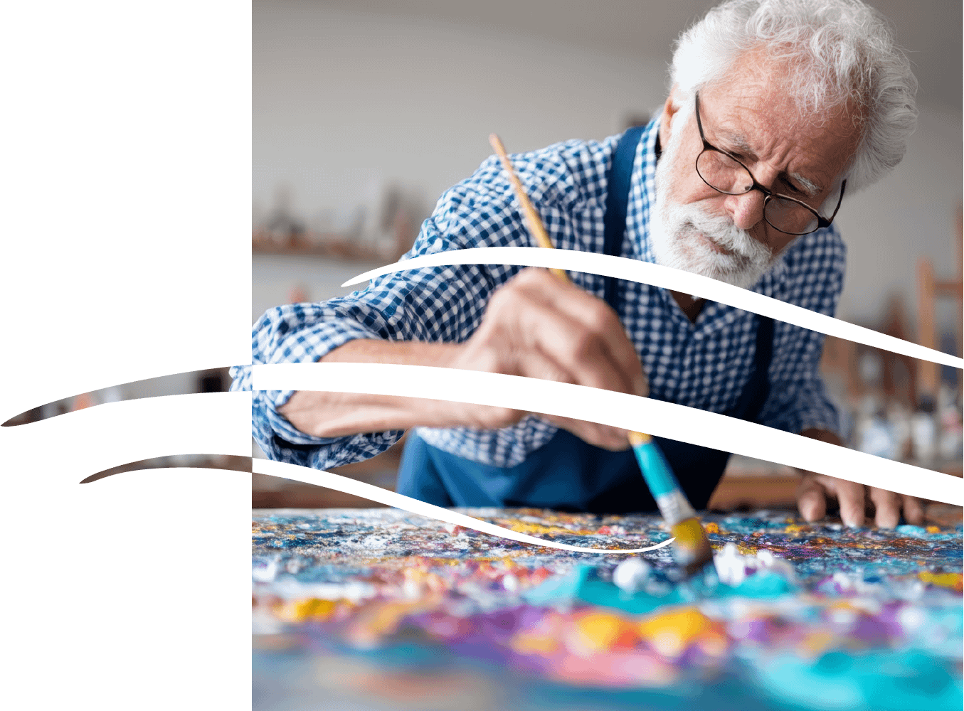 Elderly artist painting colorful abstract artwork in studio