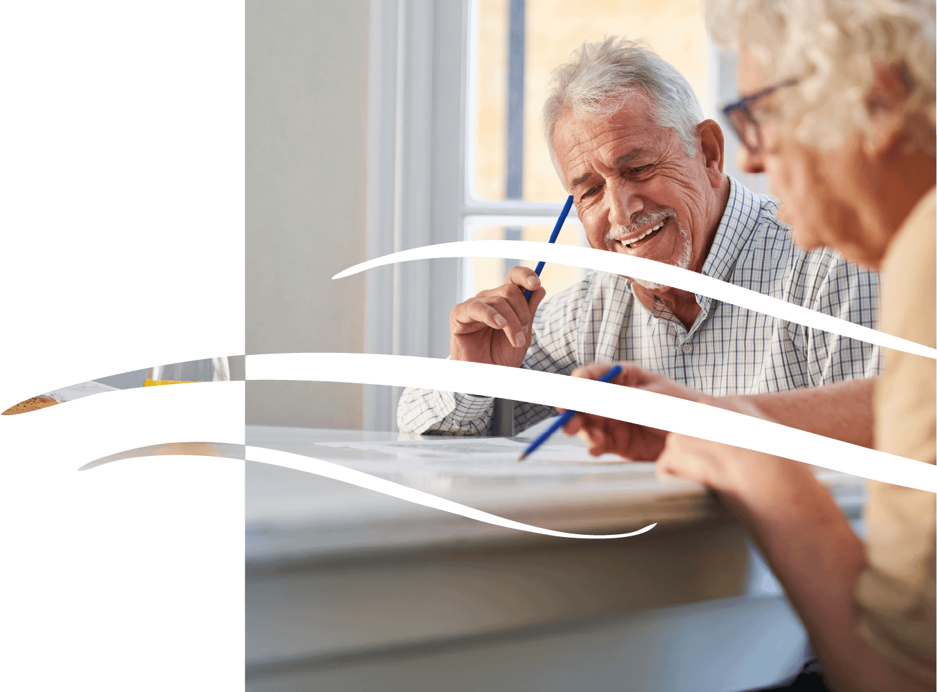Senior couple reviewing paperwork at table together
