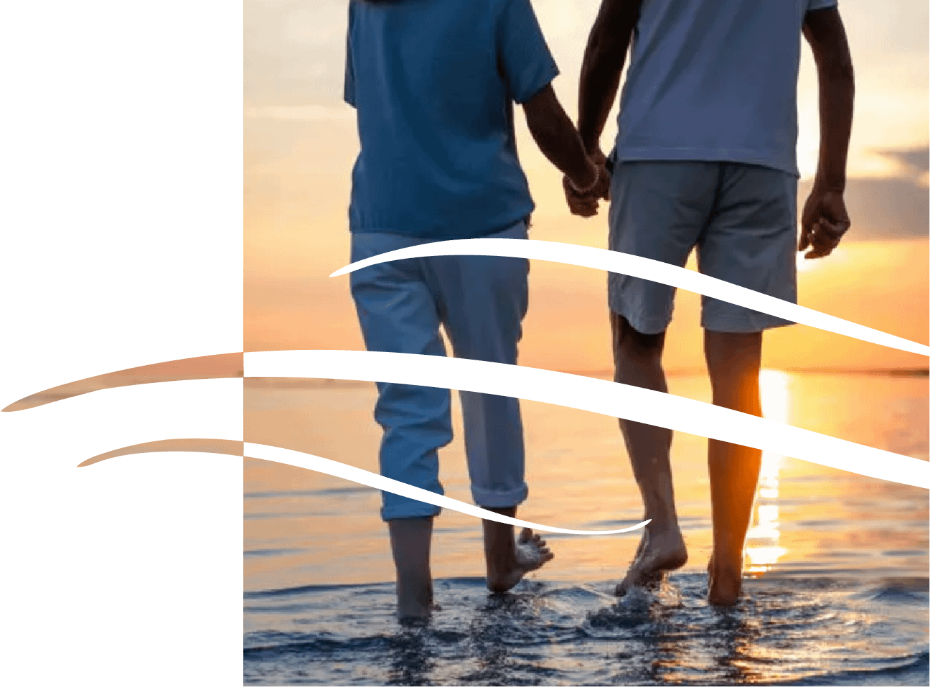 Couple holding hands walking at sunset beach