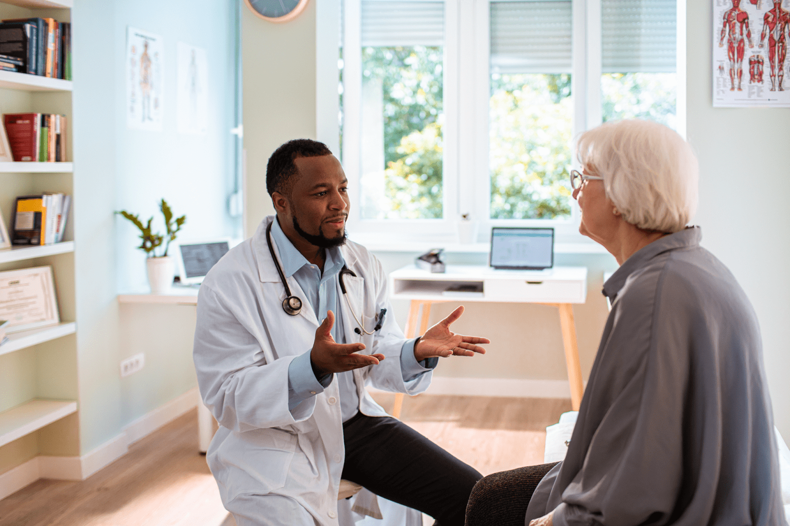 Older woman having a conversation with doctor in doctor’s office.