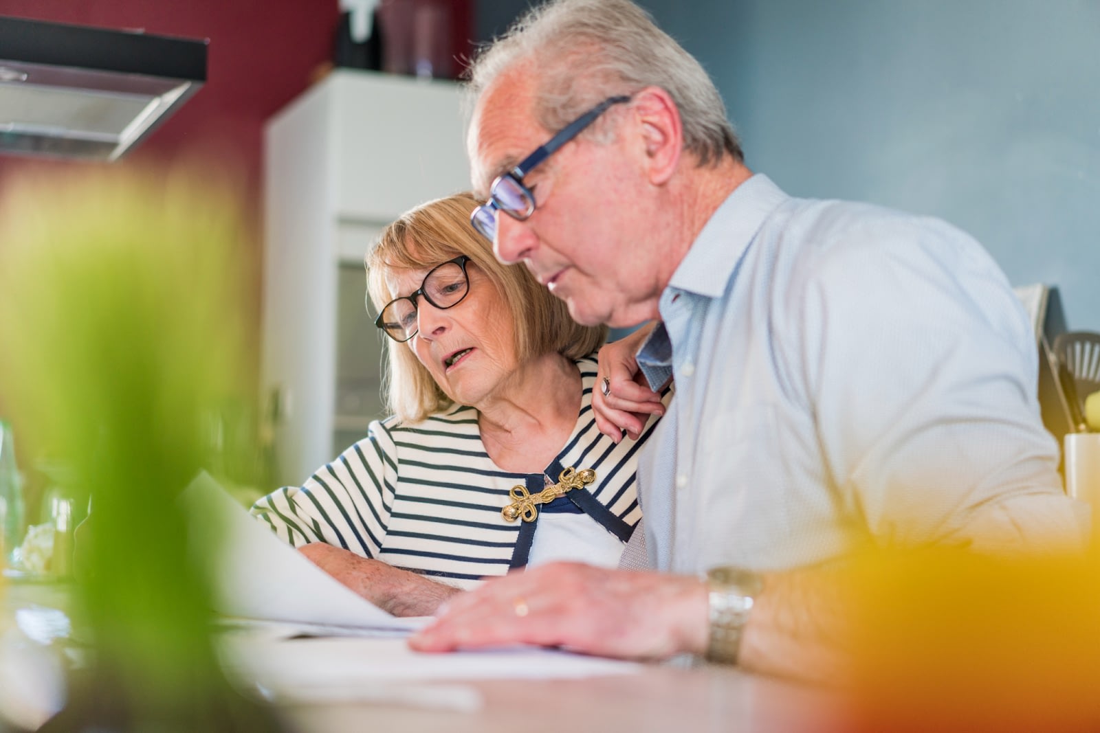 Older couple looking over paperwork in a home