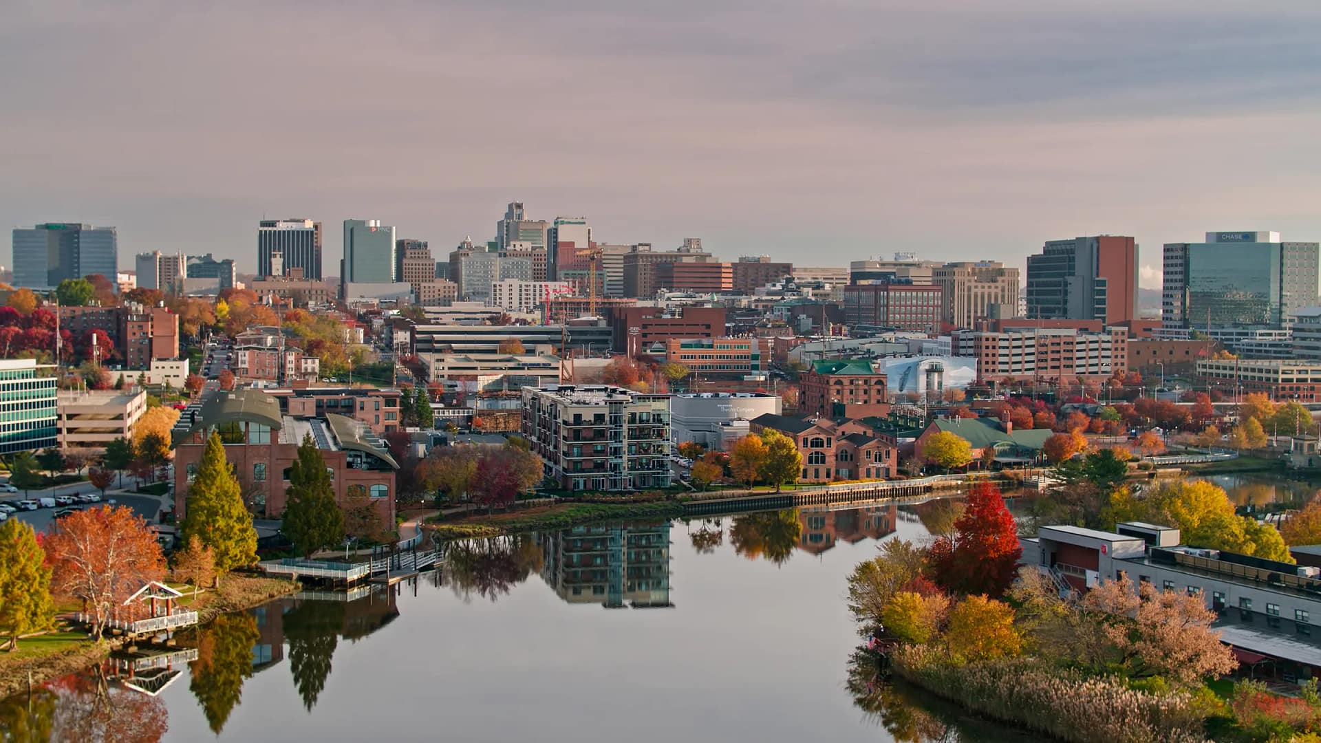City skyline reflected in river during autumn