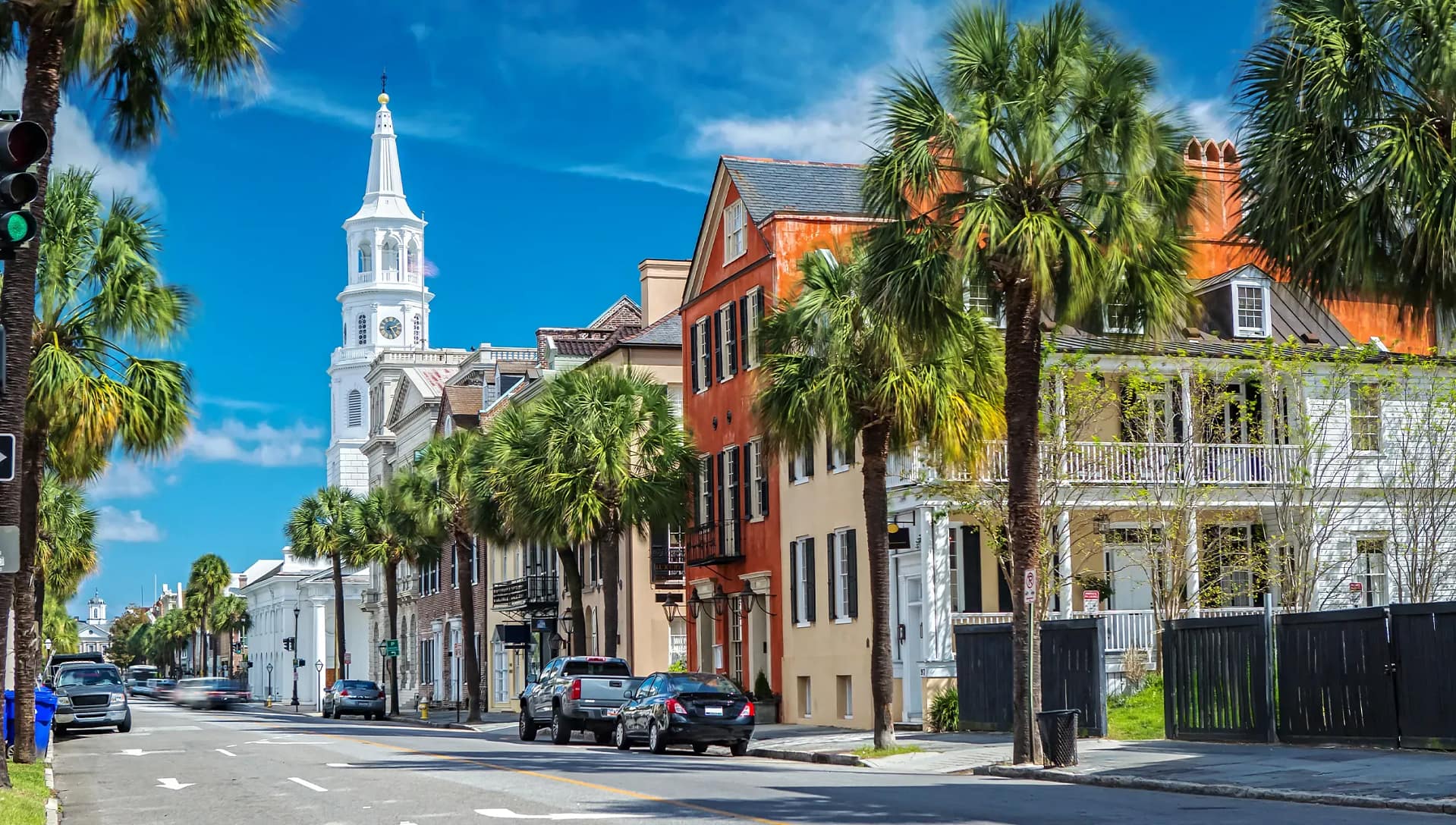 Historic downtown street with palm trees and church steeple