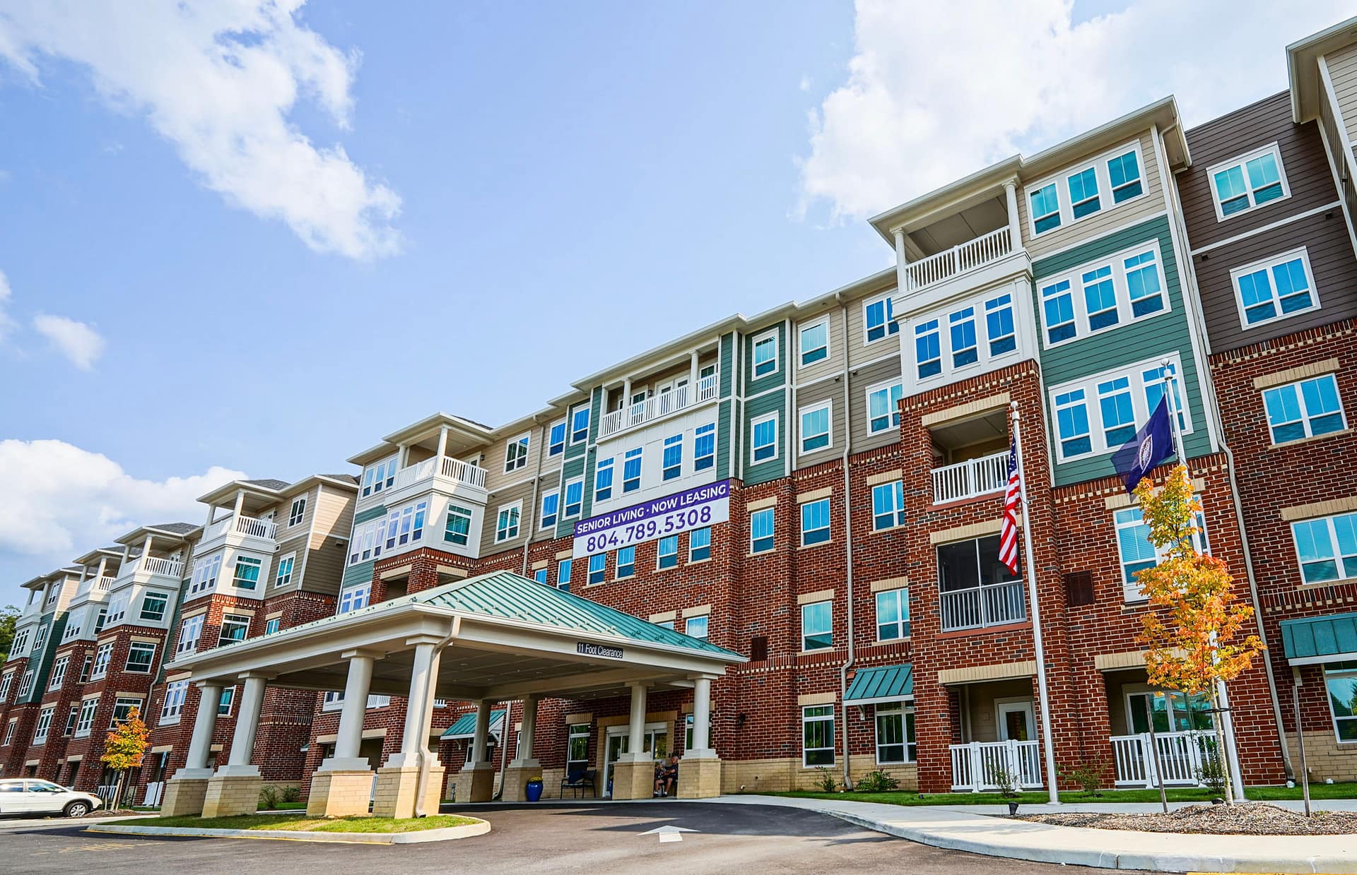 Senior living apartment building with leasing banner